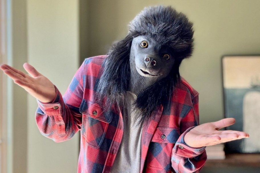 man wearing poodle mask while shrugging