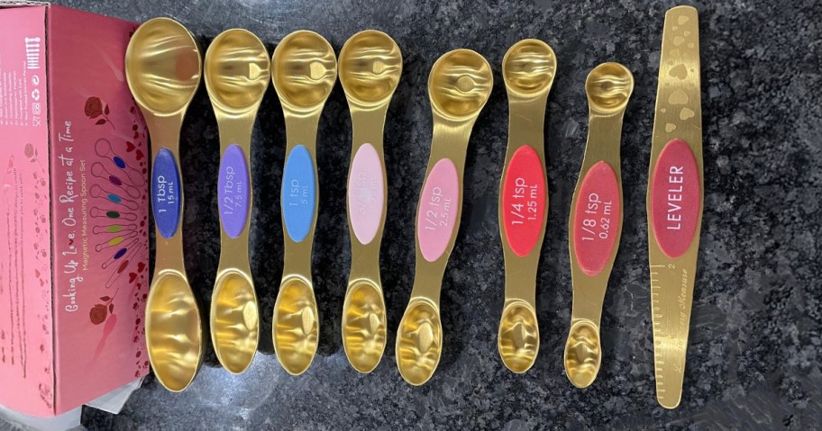 gold colorful measuring spoon set on a table