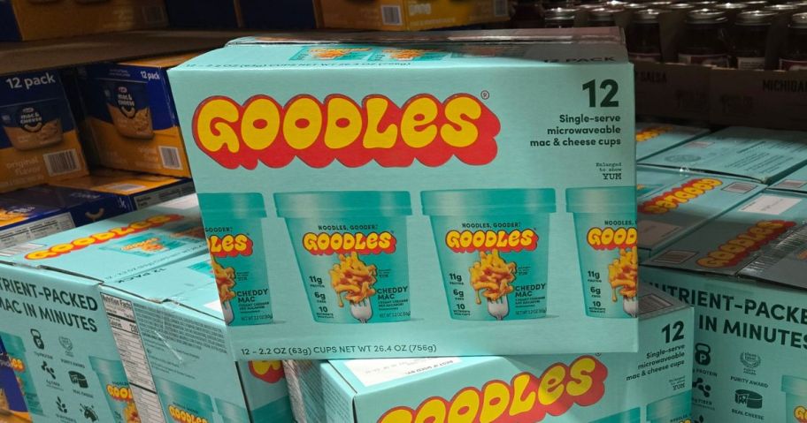 Goodles Cheddy Mac Cups 2.2oz 12-Count box on top of other boxes in store