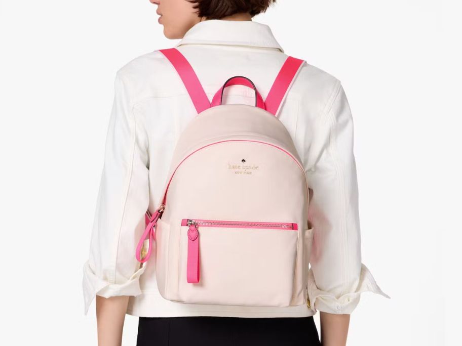 woman with pink kate spade backpack on her back
