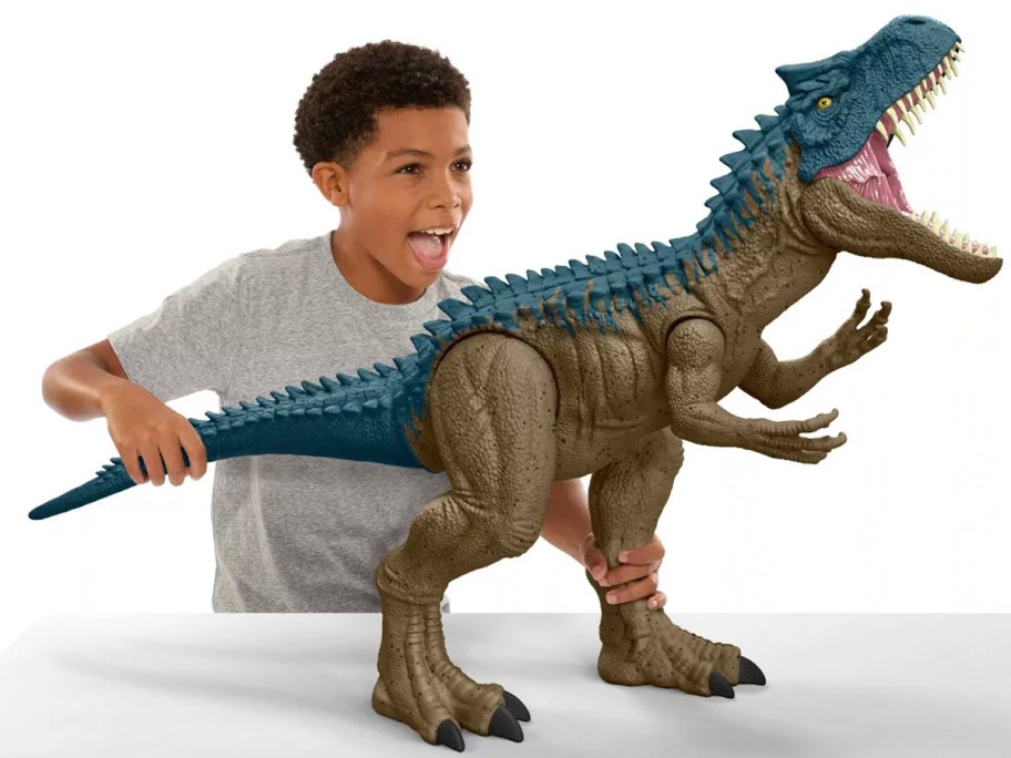 kid playing with dinosaur toy 