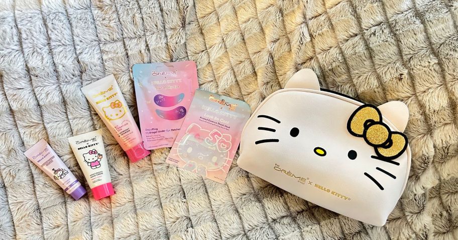 Hello Kitty Gold Mystery Bundle bag on blanket with products sitting to the left of it