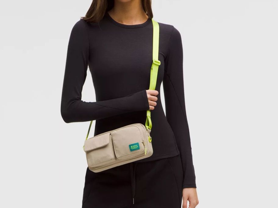 woman wearing yellow and beige lululemon Multi-Pocket Crossbody Bag around her shoulder