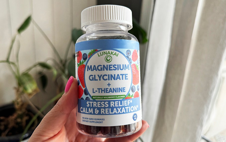 hand holding a bottle of magnesium gummies