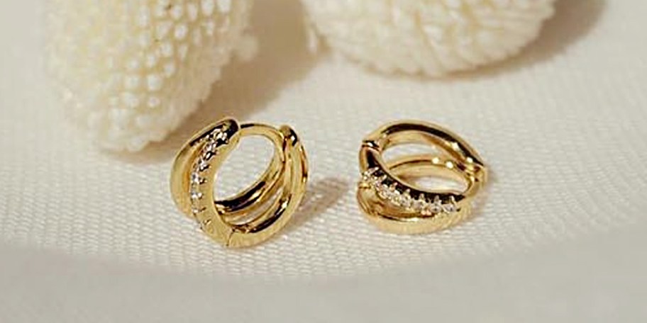 gold hoop earrings on table