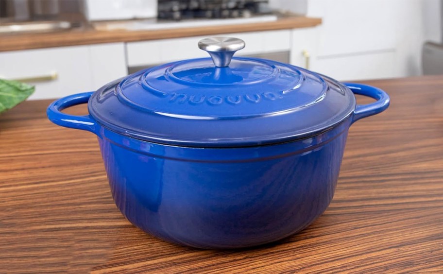 dark blue dutch oven sitting on a kitchen counter
