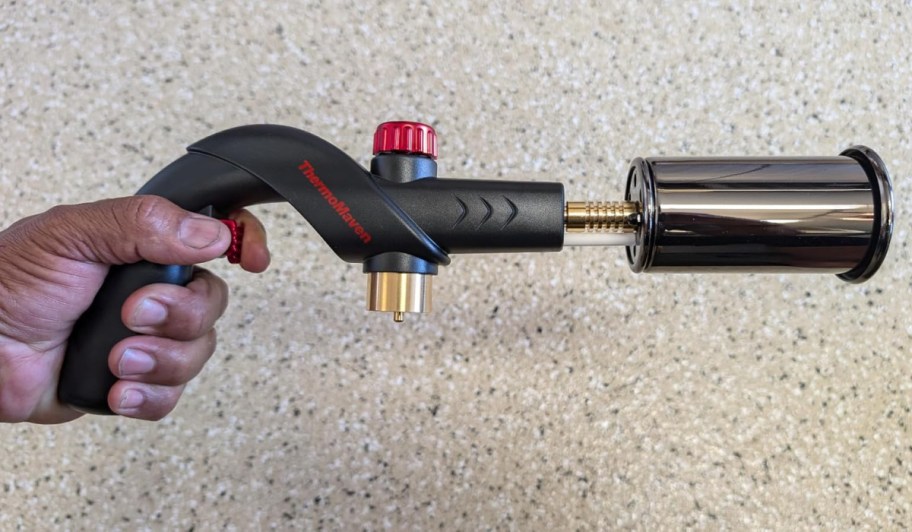 hand holding small kitchen torch top