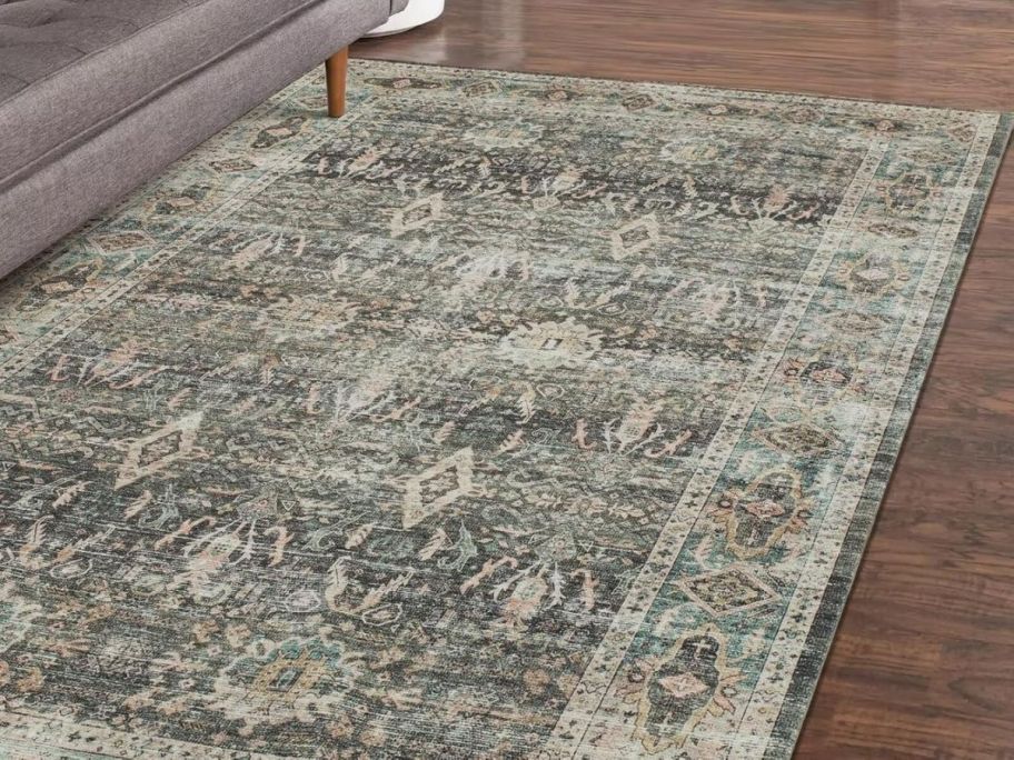 faded green printed rug in living room