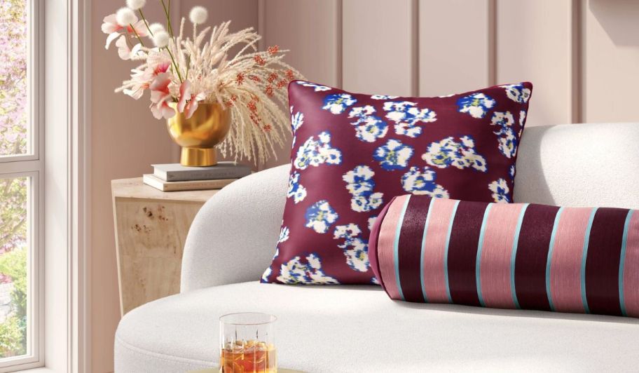 two throw pillows arranged on a sofa