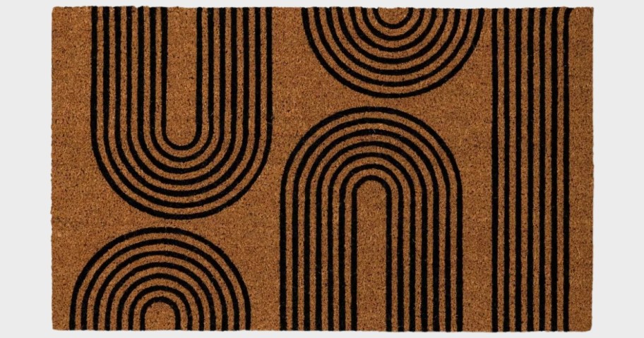 a coir doormat with black arches printed on it