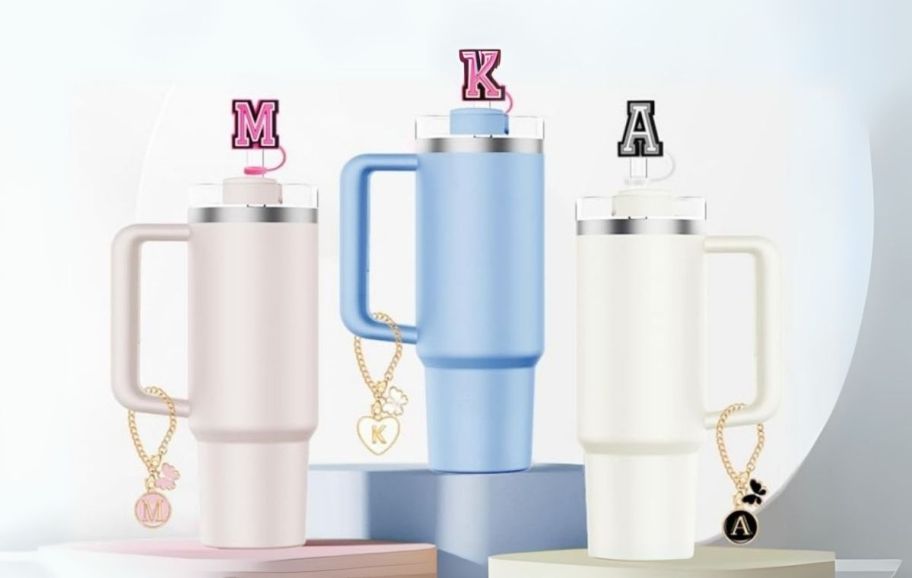 3 tumblers with straw toppers and charms 