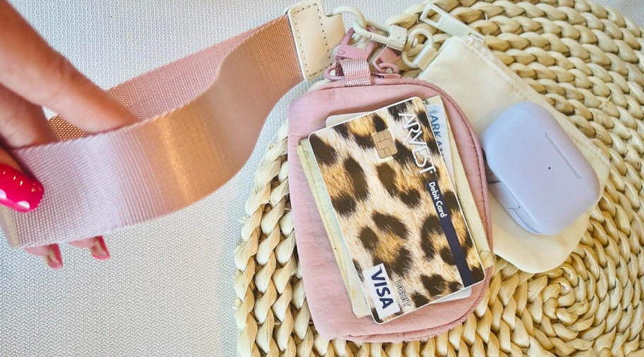 person holding onto a wristlet wallet