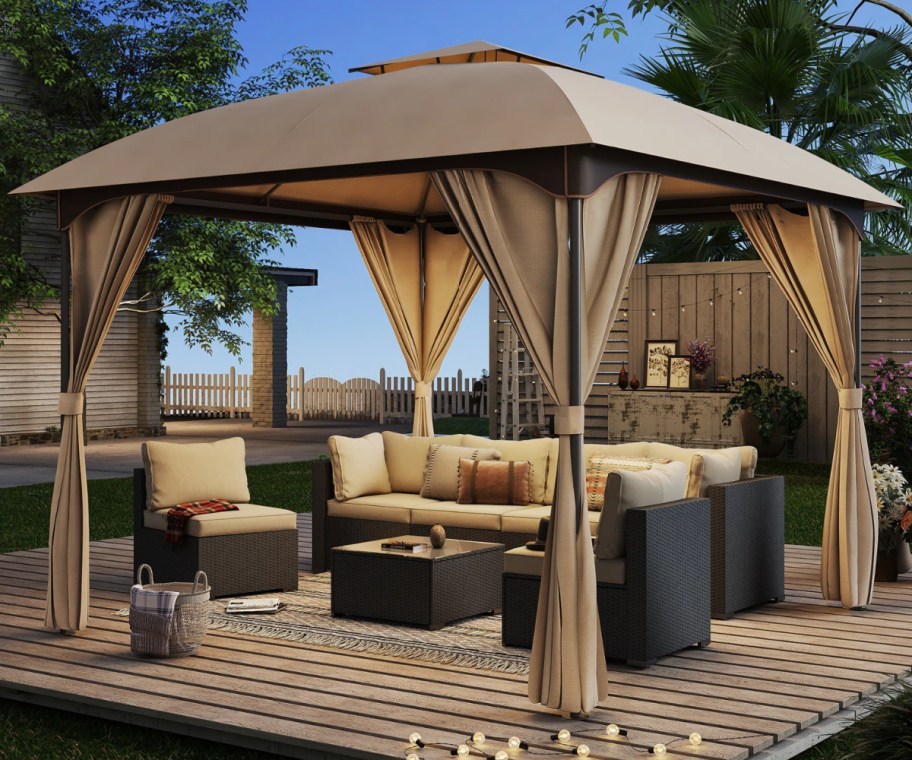 tan gazebo over futniture outside with lights