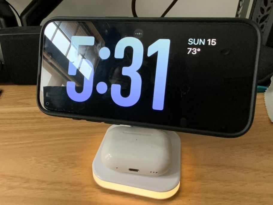 wireless charger with phone and airpods on it 