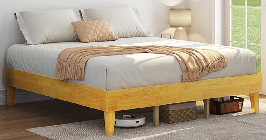 natural bed frame with mattress and bedding