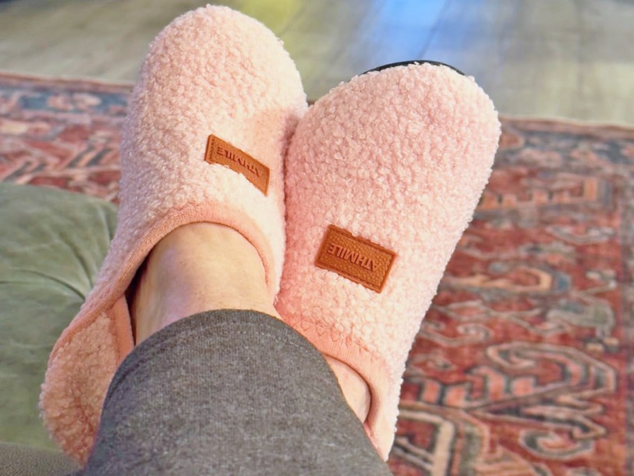 woman wearing a pair of pink fuzzy slippers