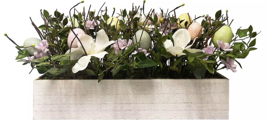 leaves, flowers, and eggs in rectangular wood box
