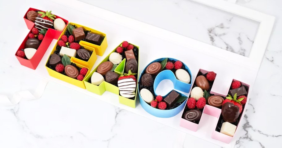 colorful letters that spell out "teach" filled with chocolates and strawberries