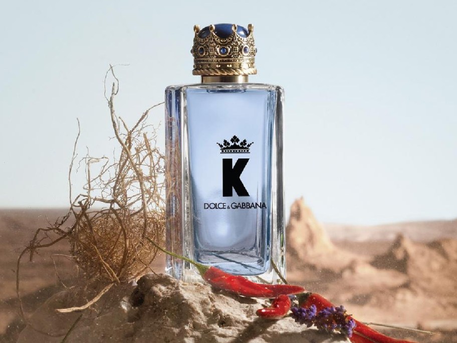 Dolce & gabbana men's cologne displayed at a desert with a red string 