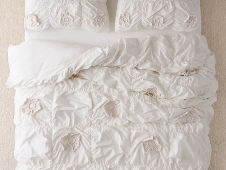A white floral duvet on a bed