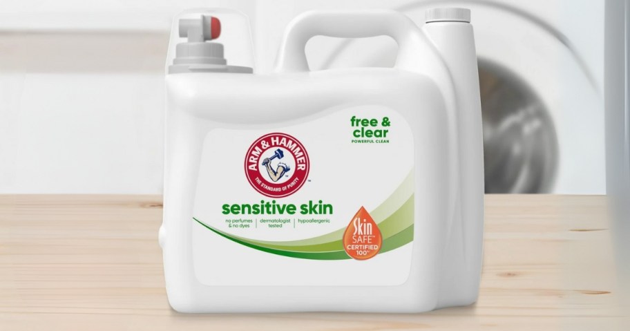 a large bottle of Arm & Hammer Sensitive Skin Free & Clear Laundry Detergent with a washing machine in the background