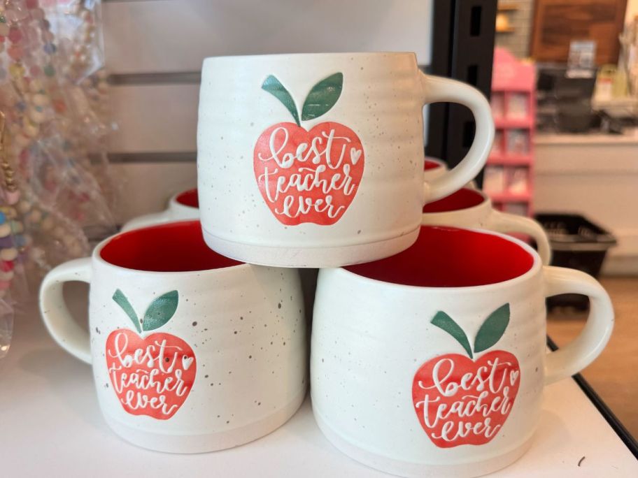 a stack of Kirkland's Best Teacher Ever Apple Mugs