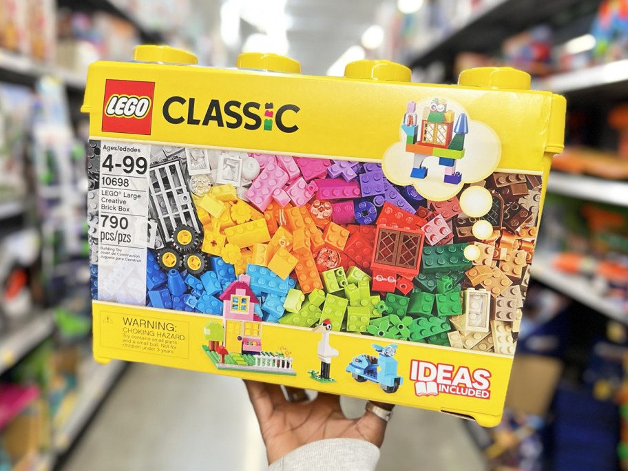 hand holding yellow LEGO Classic Large Creative Brick Box in store