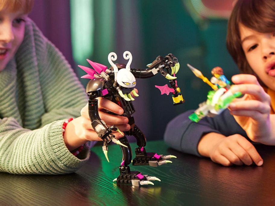 LEGO riper in kids hands while playing on top of the table