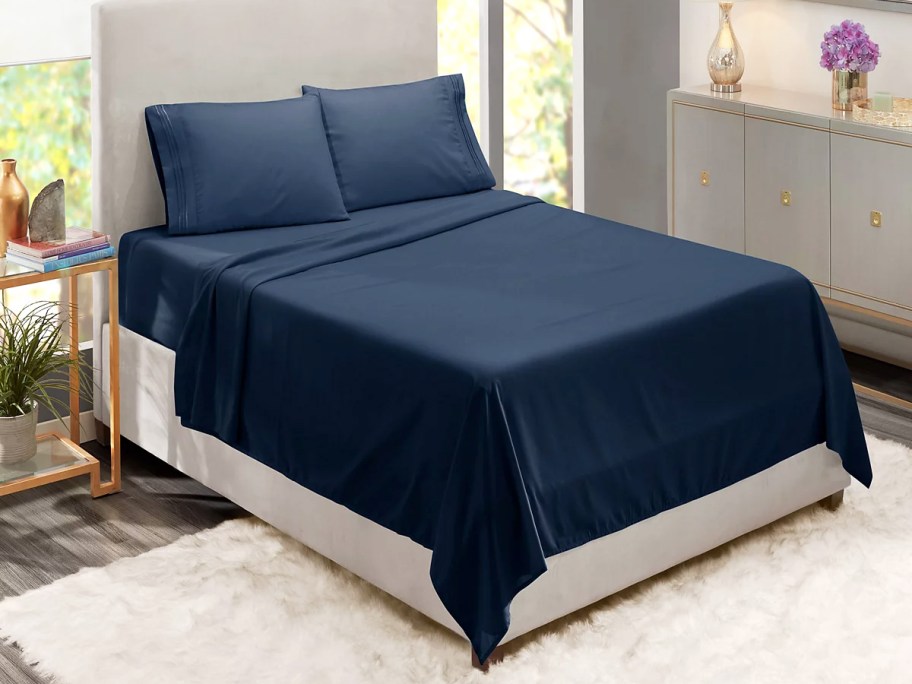 navy blue sheet set on bed with matching pillow cases