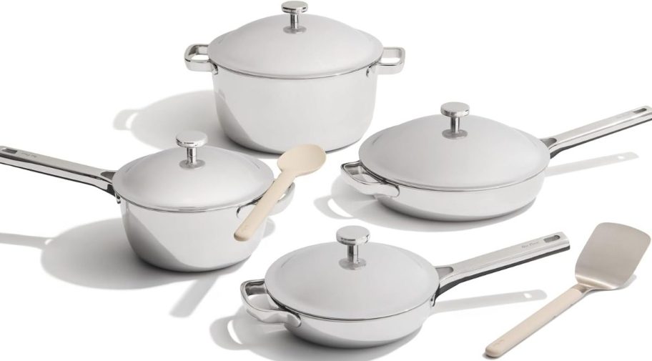 a set of 4 cooking pots and pans with lids and 2 utensils