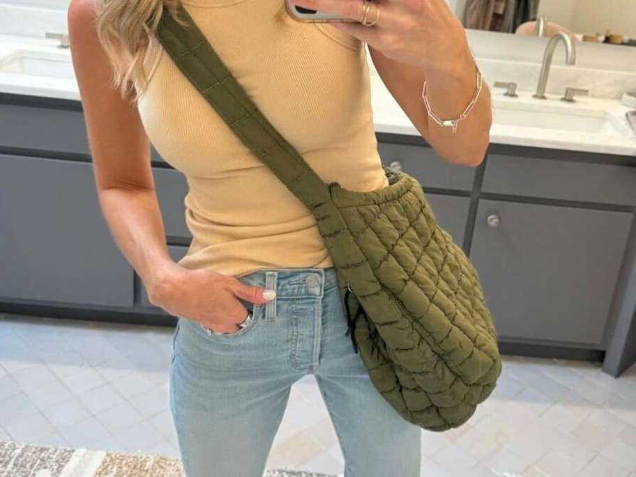 woman wearing green quilted puffer tote bag
