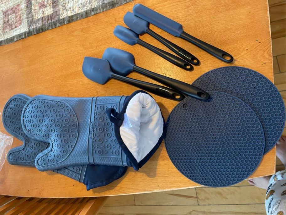 A blue oven mitt and spatula set 