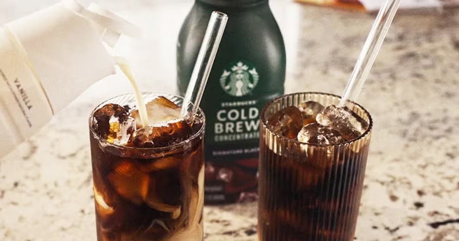 two glasses of iced coffee in front of a bottle of Starbucks Cold Brew Concentrate 
