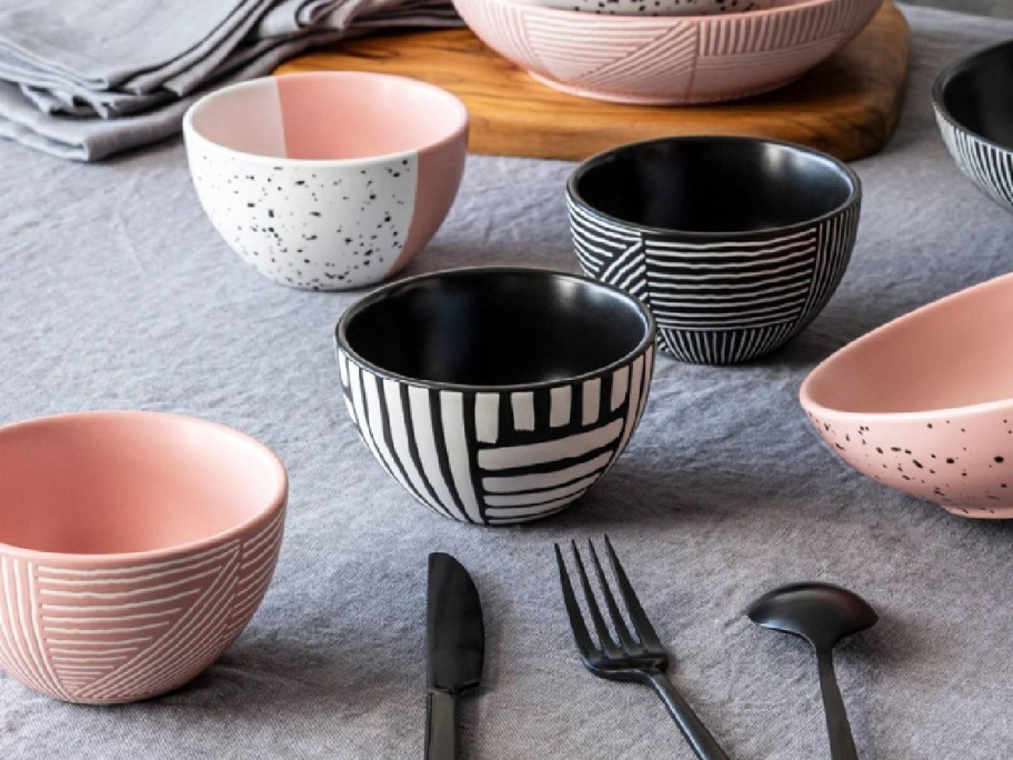small bowls displayed on top of a table with different patterns
