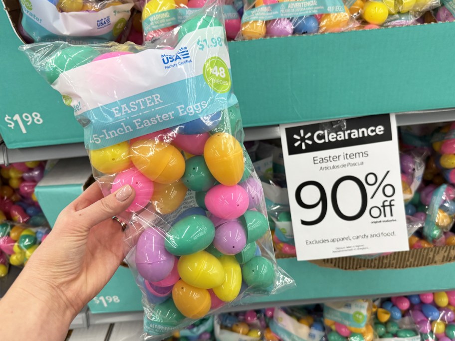 hand holding colorful pack of fillable easter eggs next to 90% off clearance sign