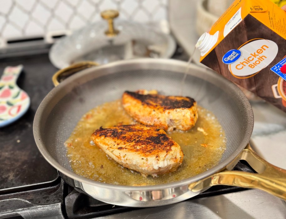 adding chicken broth to a skillet with chicken