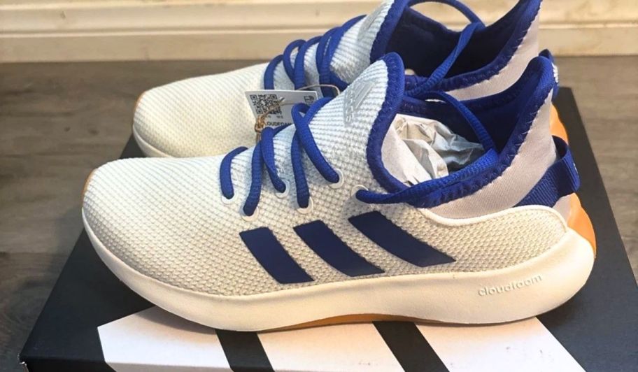a pair of womens adidas cloudfoam sneakers on top of a shoe box