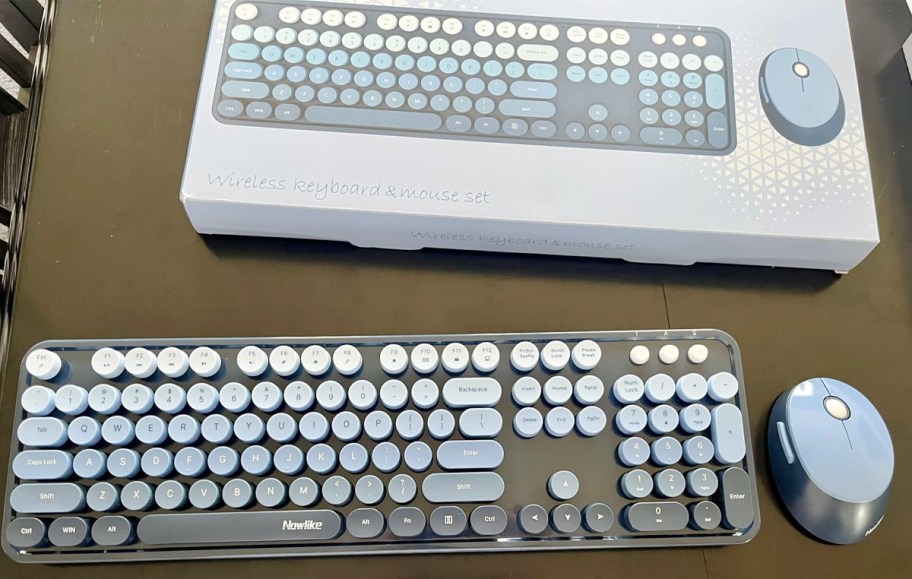 blue and black keyboard and mouse with box on table