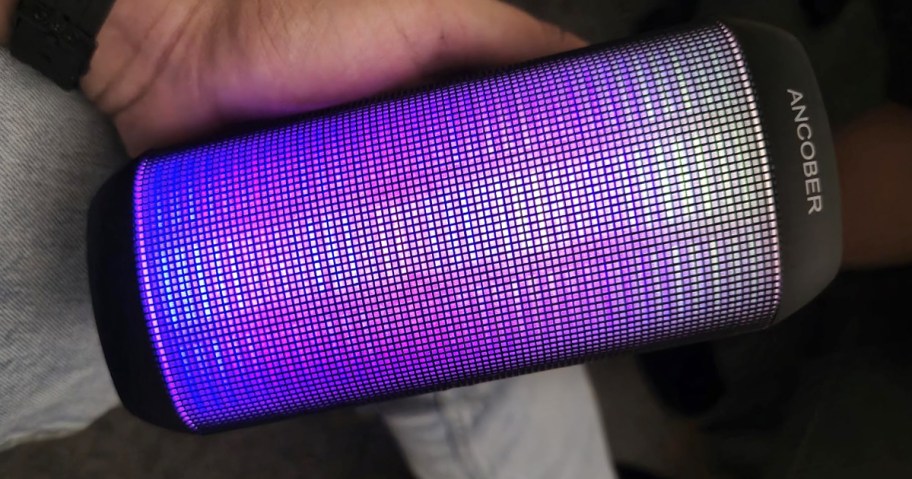 person holding colorful speaker