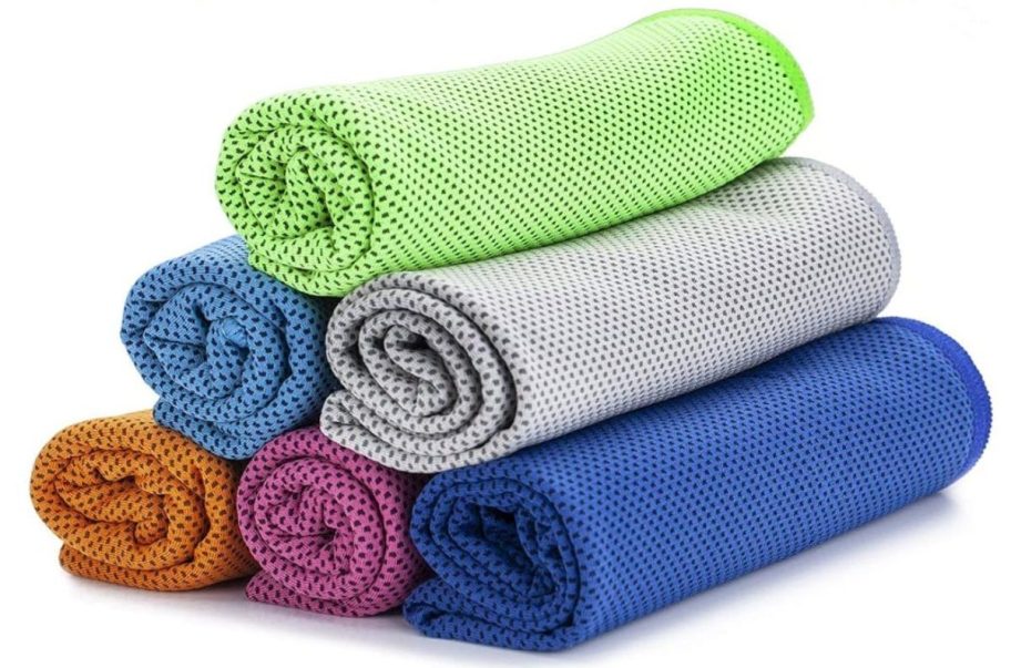 an orange, pink, blue, light blue, grey, and green cooling towel rolled up and stacked on top of each other