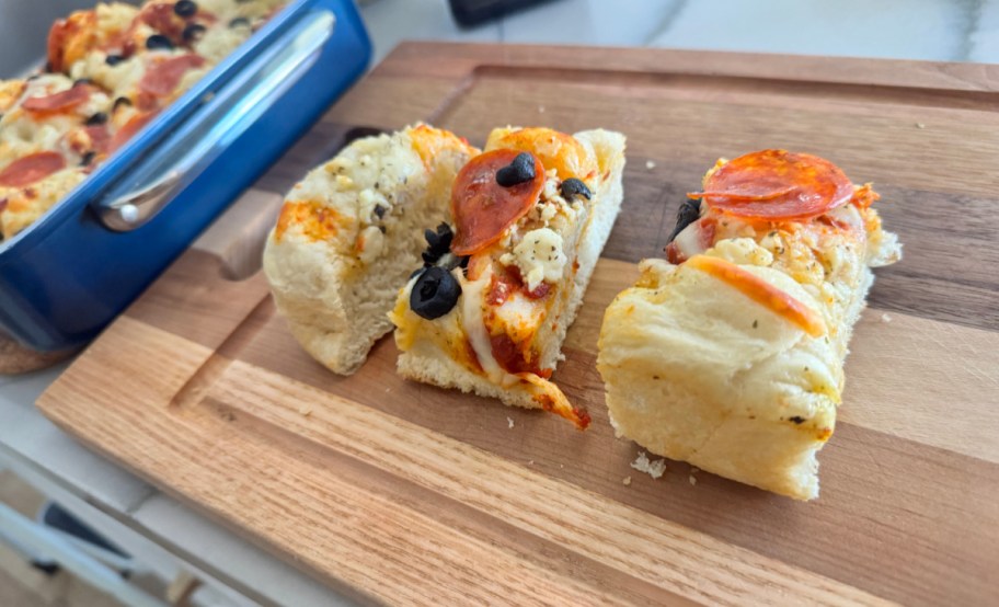 focaccia sliced on a cutting board 