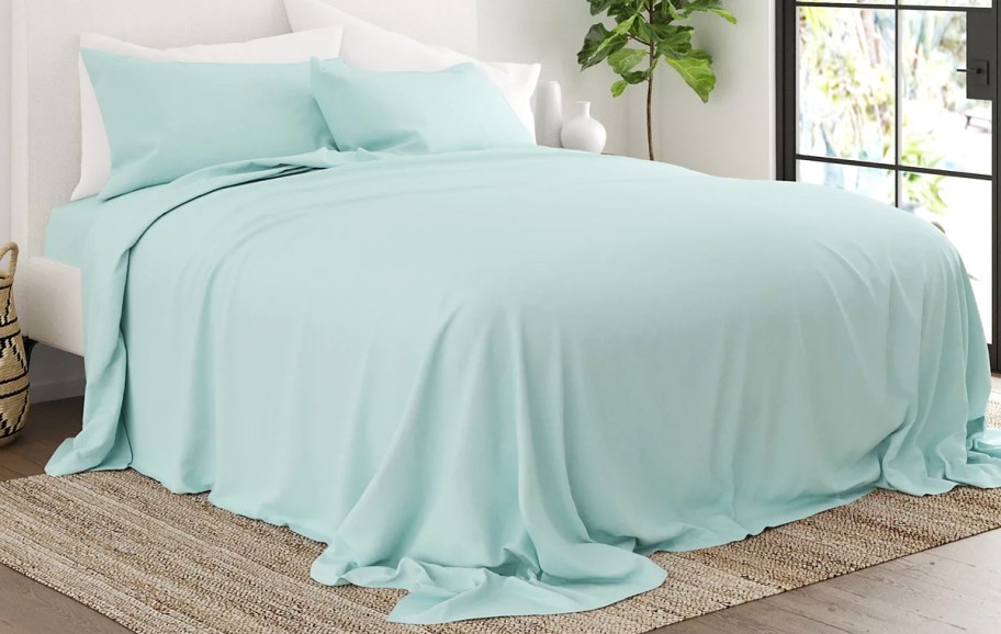 aqua blue sheet set on bed