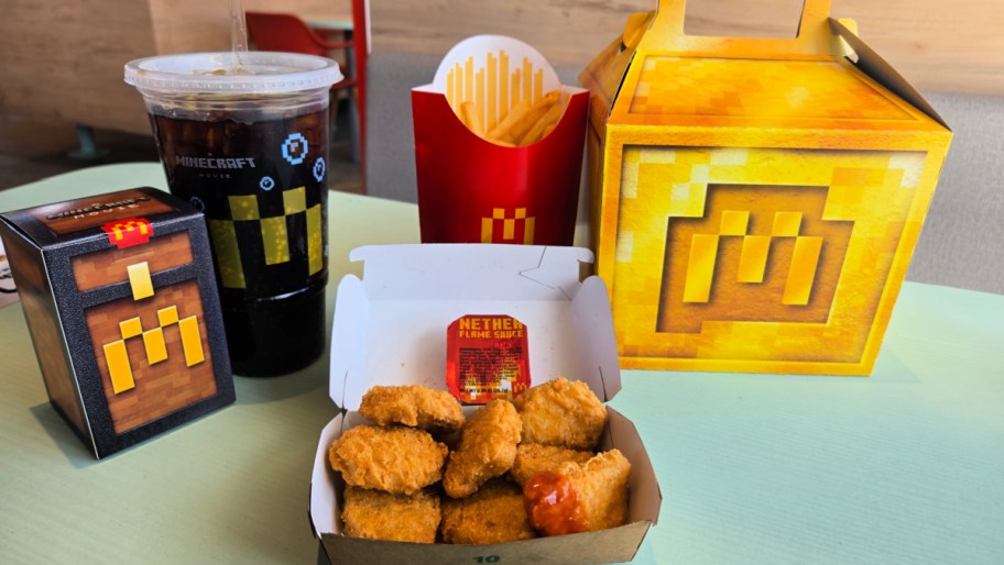 all the contents of a minecraft themed adult mconalds happy meal displayed on a table