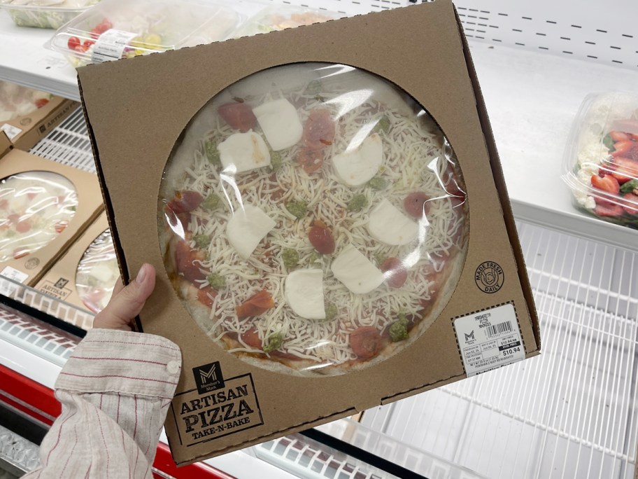 hand holding box of members mark pizza