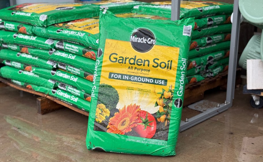 bags of miracle gro garden soil on display in a store