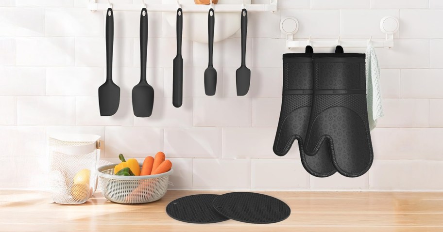oven mitt and spatula set on a wall