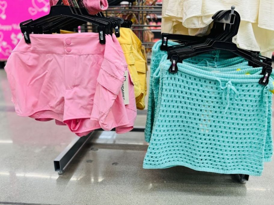 pink board shorts and an aqua colored swim coverup skirt