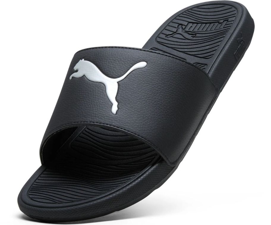 a black eva men's slide with the puma logo on the front