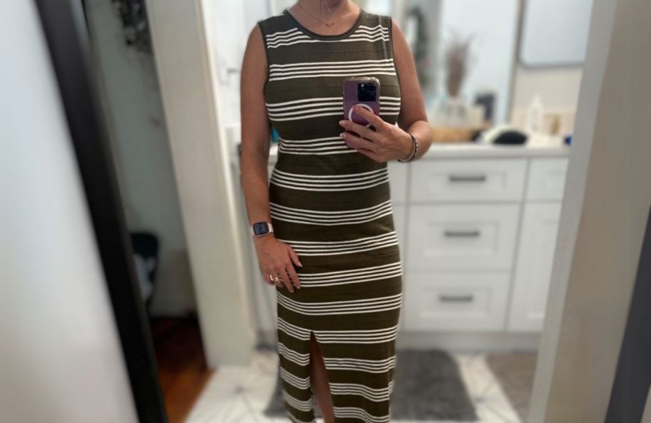 a woman taking a selfie wearing a striped sleeveless sundress