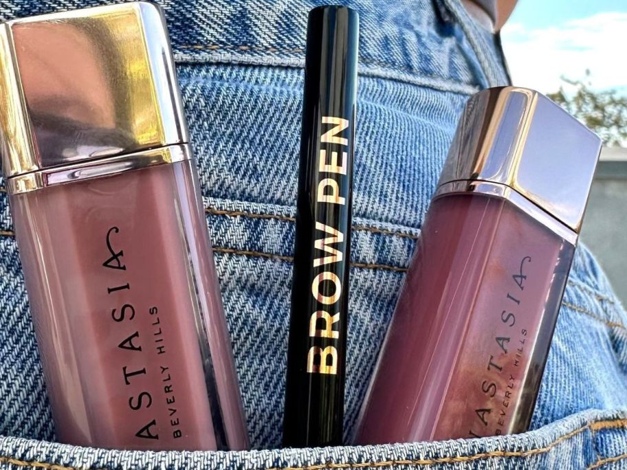 Anastasia Beverly Hills Micro-Stroking Detailing Brow Pen sticking out of a denim pocket with two other ABH products